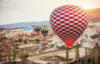 Colorful hot air balloons flying over Red valley at Cappadocia