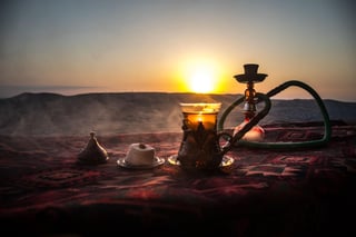 Hookah hot coals on shisha bowl making clouds of steam at desert outdoor