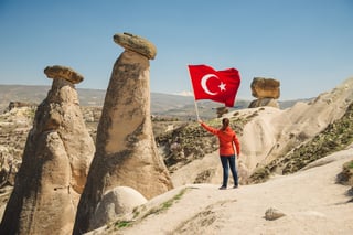 Tourist holding turkish national flag
